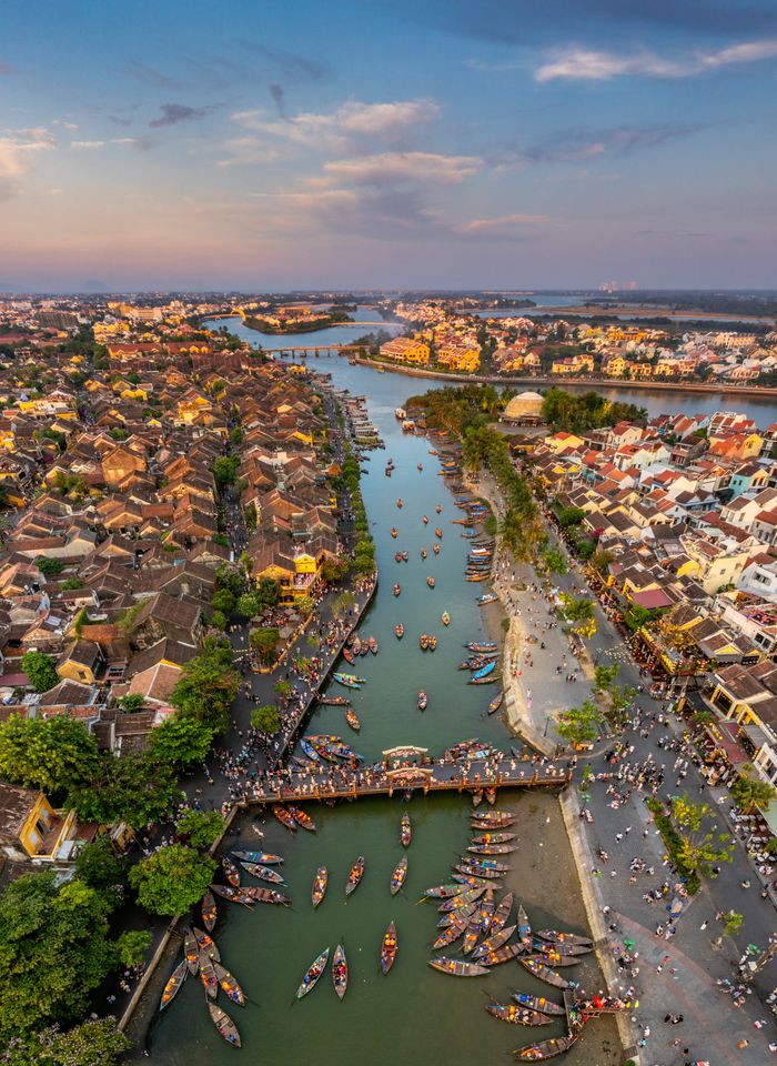 Bird's eye view of Hội An's scenic river, bridges, and vibrant cityscape.